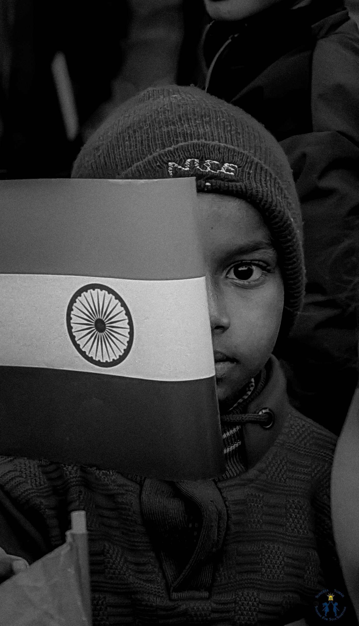 A child holding the Indian flag at a foundation event